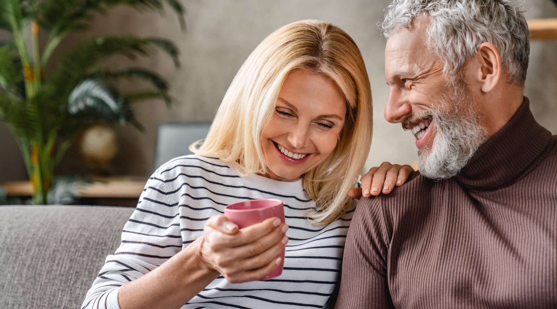 a couple on a couch laughing