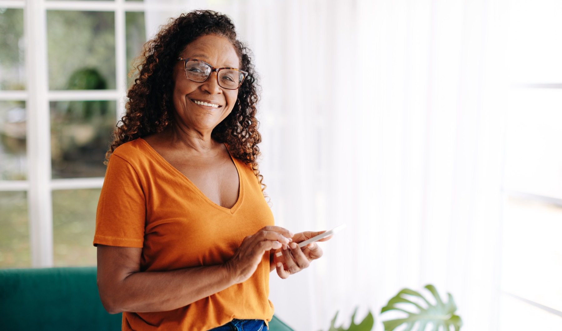 a woman smiling and on her phone