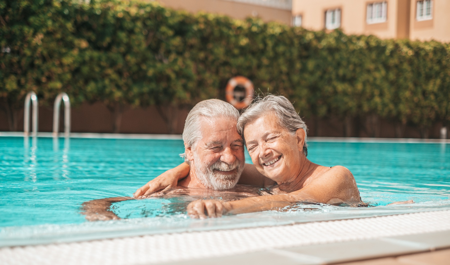 A man and woman swimming in a pool