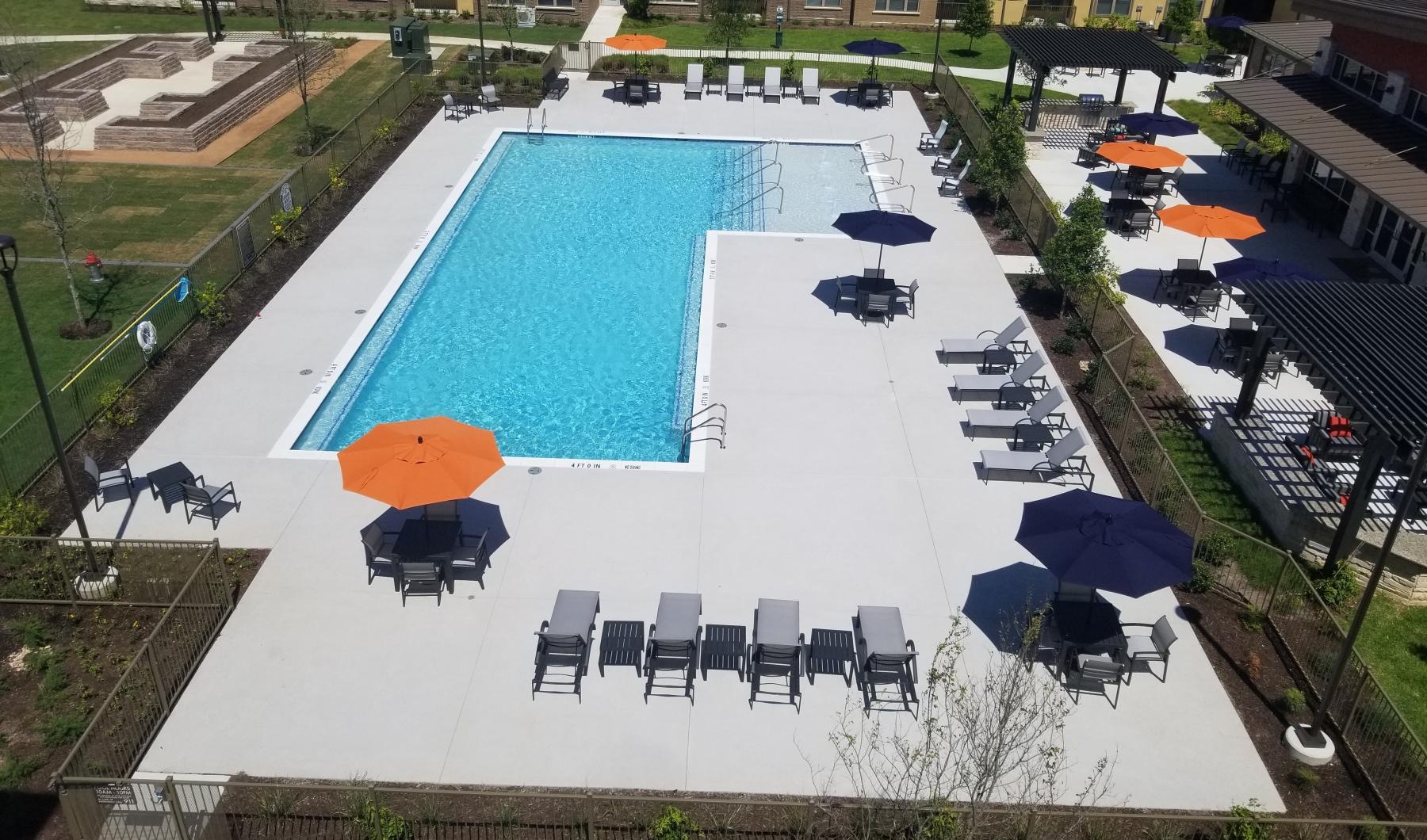 Sparkling swimming pool a pool with chairs around it