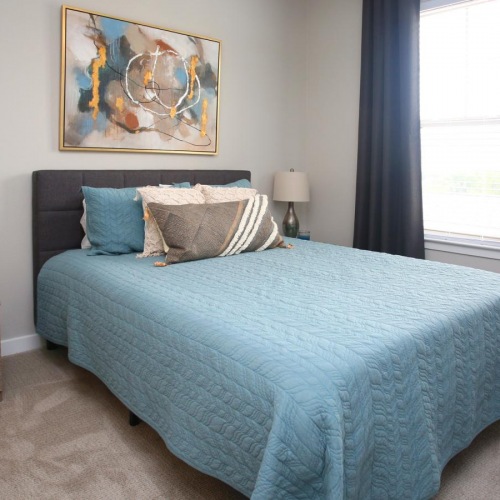 Generous bedroom offerings to fit every family Model bedroom at The Orchards at Arlington Highlands apartments in Arlington, TX, featuring two bedside tables.