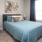 Model bedroom at The Orchards at Arlington Highlands apartments in Arlington, TX, featuring two bedside tables.