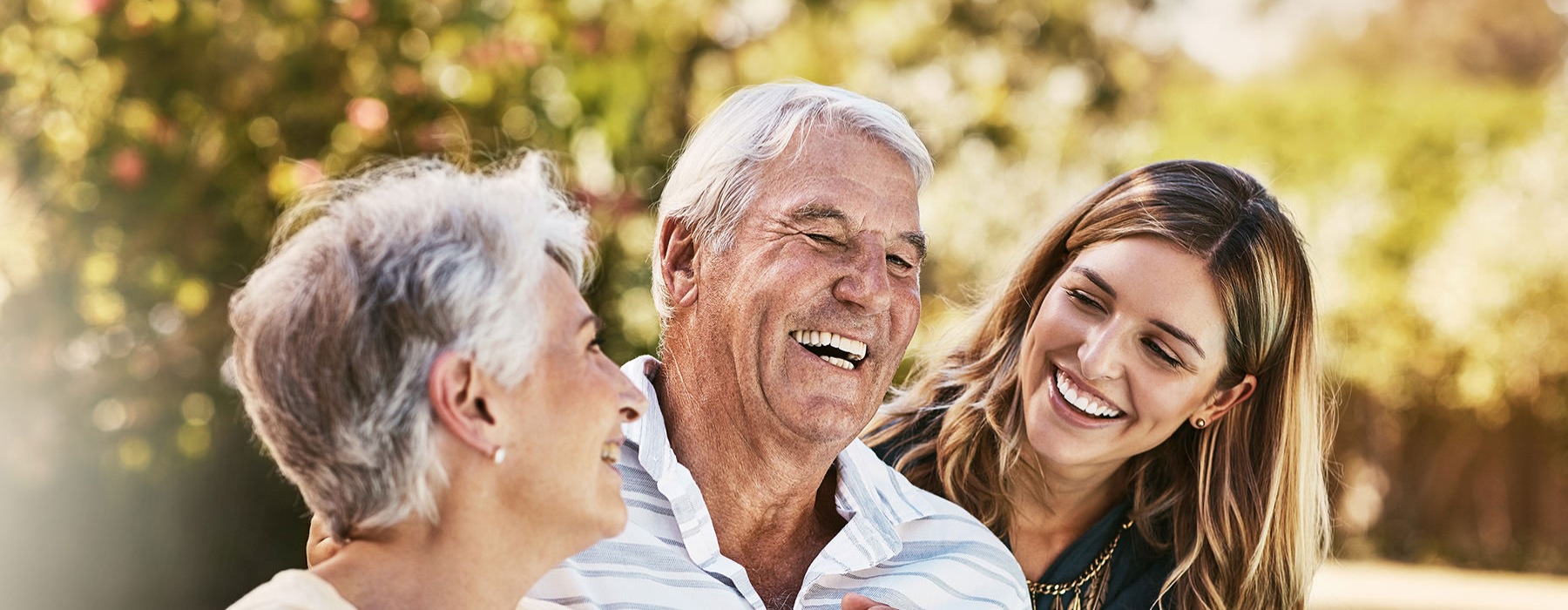 a family smiling together outdoors