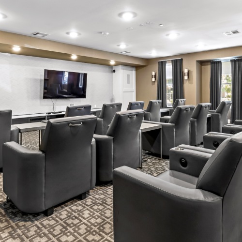 movie theater room for residents to enjoy with relaxing chairs