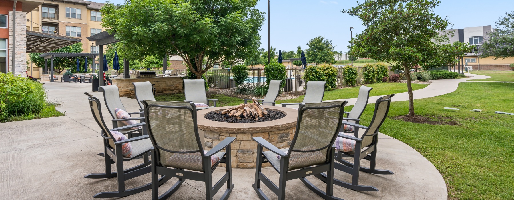 a fire pit with chairs around it 