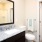 Model bathroom at The Orchards at Arlington Highlands apartments in Arlington, TX, featuring a large mirror.