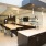 a kitchen with a bar and chairs