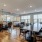 a large dining room with a large stone wall and a large stone fireplace