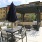 a patio with tables and chairs and umbrellas by a building